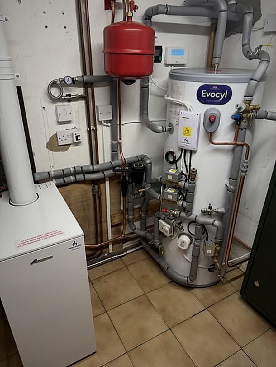 Worcester Bosch Danesmoor system boiler beside a new unvented cylinder